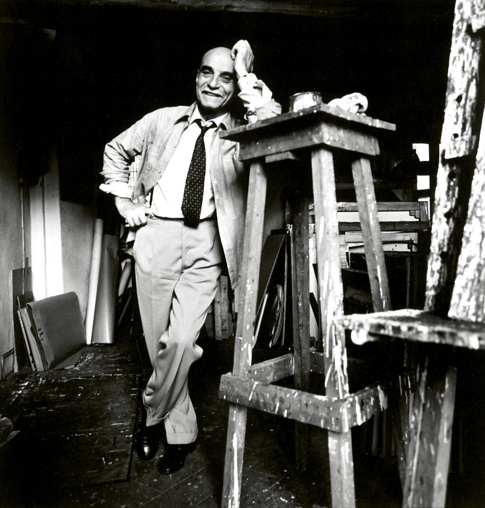Lucio Fontana in his studio. Sueddeutsche Zeitung Photo / Alamy Stock Photo.